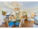 Dining area with glass top table and view into living room at 4670 Links Village Dr # B201, Ponce Inlet, FL 32127