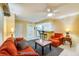 Bright living room with orange couch and view into kitchen at 4670 Links Village Dr # B201, Ponce Inlet, FL 32127