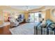 Spacious living room with hardwood floors and access to balcony at 4670 Links Village Dr # B201, Ponce Inlet, FL 32127