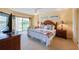 Main bedroom with large bed and access to balcony at 4670 Links Village Dr # B201, Ponce Inlet, FL 32127