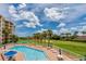 Community pool with surrounding lounge chairs at 4670 Links Village Dr # B201, Ponce Inlet, FL 32127