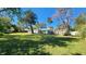 Large backyard with mature trees and grass at 623 Unabelle Ave, Holly Hill, FL 32117