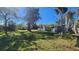 Large backyard with mature trees and grass at 623 Unabelle Ave, Holly Hill, FL 32117