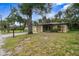 Tan house with a screened porch and a yard at 627 Clark St, Daytona Beach, FL 32114