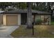 Tan house with a brown garage door and small front yard at 627 Clark St, Daytona Beach, FL 32114