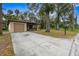 Tan house with a driveway and mature trees at 627 Clark St, Daytona Beach, FL 32114