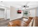 Living room with brown sectional sofa and hardwood floors at 627 Clark St, Daytona Beach, FL 32114