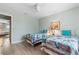 Light-filled bedroom featuring two twin beds with coastal-themed decor and light-colored, wood-look flooring at 66 Ocean Palm Villa S, Flagler Beach, FL 32136