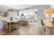 Inviting dining area adjacent to the kitchen, featuring a modern light fixture and a stylish round mirror at 66 Ocean Palm Villa S, Flagler Beach, FL 32136