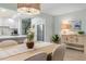 Dining area with modern chandelier, view into kitchen with stainless fridge, and light wood-look floors at 66 Ocean Palm Villa S, Flagler Beach, FL 32136