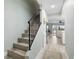 View from stairs towards the living area, showcasing the light-filled open floor plan and wood-look flooring at 66 Ocean Palm Villa S, Flagler Beach, FL 32136