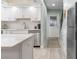 View of kitchen featuring quartz countertop, stainless steel appliances, and white cabinets with subway tile backsplash at 66 Ocean Palm Villa S, Flagler Beach, FL 32136