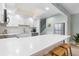 Bright kitchen with white cabinetry, stainless steel appliances, and a large quartz countertop island with seating at 66 Ocean Palm Villa S, Flagler Beach, FL 32136