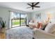 Cozy living room featuring a comfortable sofa, stylish rug, and scenic view of the outdoors at 66 Ocean Palm Villa S, Flagler Beach, FL 32136