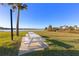 Picturesque picnic area with a white picnic table by the water's edge under blue skies at 66 Ocean Palm Villa S, Flagler Beach, FL 32136