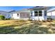 View of home from backyard showcasing screened porch at 707 Hang Loose Way, Daytona Beach, FL 32124