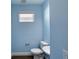 Small light blue bathroom with toilet and sink at 707 Hang Loose Way, Daytona Beach, FL 32124