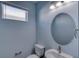 Light blue bathroom with a round mirror and sink at 707 Hang Loose Way, Daytona Beach, FL 32124