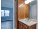 Modern bathroom with wood vanity, white countertop, and spacious mirror at 707 Hang Loose Way, Daytona Beach, FL 32124