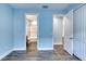 Light blue bedroom with wood floors and access to bathroom at 707 Hang Loose Way, Daytona Beach, FL 32124