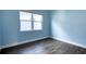 Blue bedroom with wood flooring and a window at 707 Hang Loose Way, Daytona Beach, FL 32124