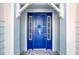 Blue front door accented with a teal ribbon at 707 Hang Loose Way, Daytona Beach, FL 32124