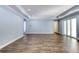 Spacious living area with wood-look floors and access to a patio at 707 Hang Loose Way, Daytona Beach, FL 32124