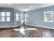 Bright living room with light blue walls and wood-look tile floors at 707 Hang Loose Way, Daytona Beach, FL 32124