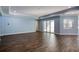 Spacious living room with light blue walls and wood-look tile floors at 707 Hang Loose Way, Daytona Beach, FL 32124