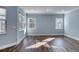 Sunlit living room with light blue walls and wood-look tile floors at 707 Hang Loose Way, Daytona Beach, FL 32124