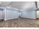 Bright living room featuring light blue walls and wood-look tile floors at 707 Hang Loose Way, Daytona Beach, FL 32124