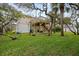 Elevated home with deck surrounded by lush landscaping at 124 Avalon Dr, Ormond Beach, FL 32176