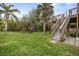 Backyard with grassy lawn and wooden stairs at 124 Avalon Dr, Ormond Beach, FL 32176