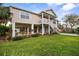 Two-story elevated beach home with palm trees and a spacious yard at 124 Avalon Dr, Ormond Beach, FL 32176