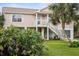 Two-story elevated beach home with palm trees and a spacious yard at 124 Avalon Dr, Ormond Beach, FL 32176