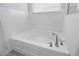 White bathtub with modern fixtures in a bright bathroom at 2840 Monaghan Dr, Ormond Beach, FL 32174