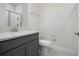 Small bathroom with gray vanity, quartz countertop, and toilet at 2840 Monaghan Dr, Ormond Beach, FL 32174