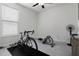 Bedroom with window, exercise bike, rowing machine and fan at 2840 Monaghan Dr, Ormond Beach, FL 32174