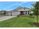 Gray two-story house with a two-car garage, landscaped yard, and a covered porch at 2840 Monaghan Dr, Ormond Beach, FL 32174