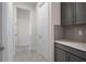 Hallway with gray cabinets, quartz countertops, and a door at 2840 Monaghan Dr, Ormond Beach, FL 32174