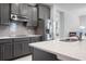 Modern kitchen with gray cabinets and stainless steel appliances at 2840 Monaghan Dr, Ormond Beach, FL 32174