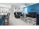 Relaxing living room featuring dark gray reclining sofas and a blue accent wall at 2840 Monaghan Dr, Ormond Beach, FL 32174