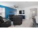 Relaxing living room featuring leather furniture and a large TV at 2840 Monaghan Dr, Ormond Beach, FL 32174