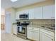 View of the kitchen's stainless steel appliances and white cabinets at 4641 S Atlantic Ave # 2010, Port Orange, FL 32127