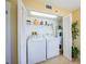 Laundry closet with washer, dryer, and shelving at 4641 S Atlantic Ave # 2010, Port Orange, FL 32127