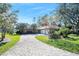 Brick home with three-car garage and paved driveway at 56 Winding Creek Way, Ormond Beach, FL 32174