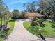 Single-story home with a paved driveway and lush landscaping at 56 Winding Creek Way, Ormond Beach, FL 32174