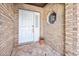 Front entry with white door and brick exterior at 56 Winding Creek Way, Ormond Beach, FL 32174