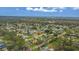 Aerial view of a residential neighborhood with houses, trees, and a body of water at 89 Hickory Hills Cir, Ormond Beach, FL 32174