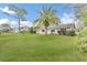 Gray house with palm tree and green lawn at 89 Hickory Hills Cir, Ormond Beach, FL 32174